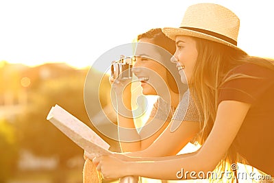 Two tourists photographing from an hotel balcony Stock Photo