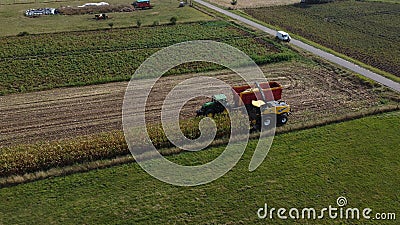 Two tractors harvesting corn in a field Editorial Stock Photo