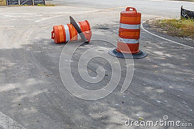 Two traffic barrels, one overturned, metaphor for safe driving, construction zone, accidents, creative copy space Stock Photo