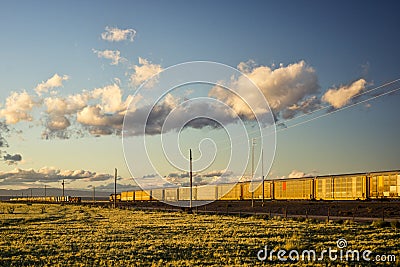 Two Trains Passing Each Other at Sunset Stock Photo