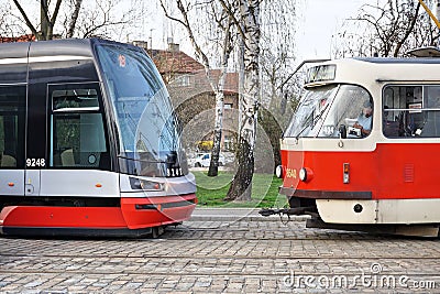 Two tram carriages with one very modern and one outmoded as a contrast of new and old Editorial Stock Photo