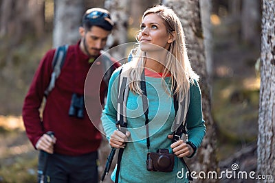 Two travel hikers with backpack walking while looking the landscape in the forest Stock Photo