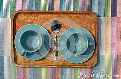 Two turquoise coffee cups on a wooden tray Stock Photo