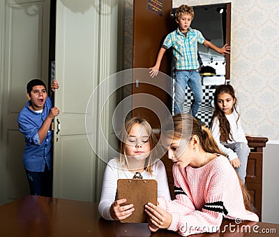 Two tween girls solving conundrum to get out of escape room Stock Photo