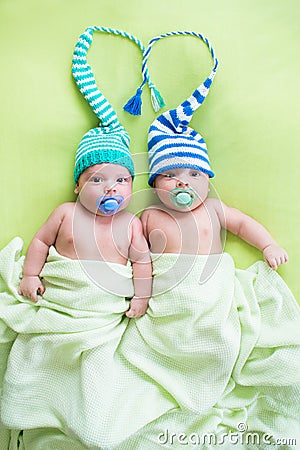 Two twins brothers babies weared in hats Stock Photo