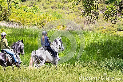 Two unidentified women riding horses on the hills of south San Francisco bay area, Santa Clara county, California Editorial Stock Photo