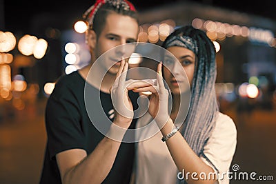 Two unusual young couple hip-hopers portrait in night city Stock Photo