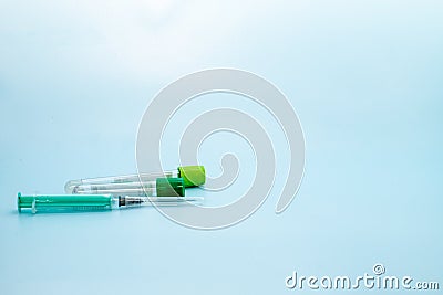 Two vacuum tubes for collection and blood samples and syringe on blue background for laboratory Stock Photo