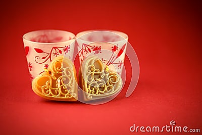 Two Valentine's candles on red background Stock Photo