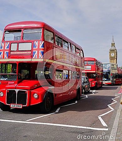 Line of Red Double Decker Buses near Big Ben - London Editorial Stock Photo