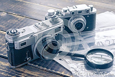 Two vintage film cameras, a black and white negative film in the Stock Photo