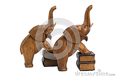 Two vintage old wooden carved brown elephants holders with raised trunks Stock Photo