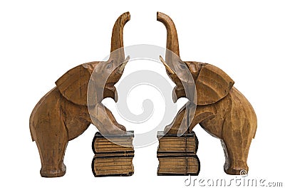 Two vintage old wooden carved brown elephants holders with raised trunks Stock Photo