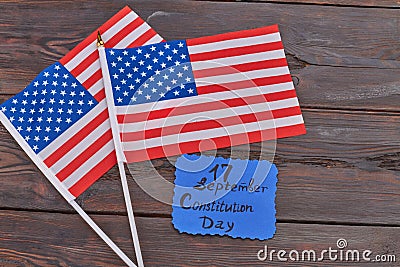 Two wave flags of the United States on woodek desk. Stock Photo