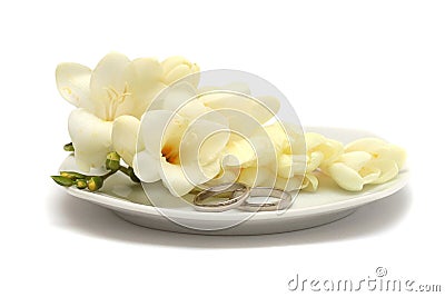 Two wedding platinum rings and white flowers Stock Photo