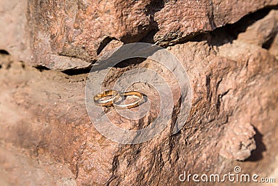 Two wedding rings on a stone wall Stock Photo