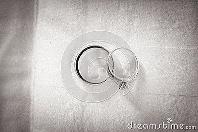 Two wedding rings on a textured background Stock Photo