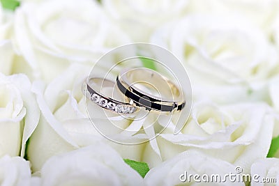 Wedding white roses engagement gold jewelry couple rings ring romance rose love bride bridal marriage ceremony married anniversary Stock Photo