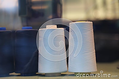 Two white bobbins tailor shop Stock Photo