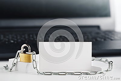 Two white business cards on PC background, lock, chain. Protection of business and finance. Protection of personal information and Stock Photo