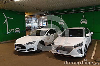 Two Electric cars charging in parking house Stock Photo