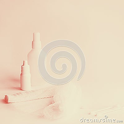 Two white medicine bottles big and little, roller bandage and three cotton buds on the white background Square shot with Stock Photo