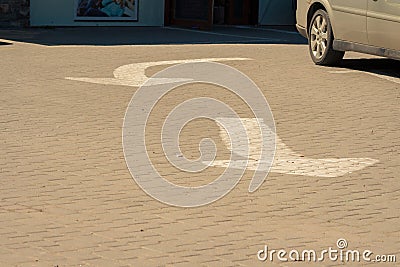 Two white road arrows. Textured grey asphalt Stock Photo