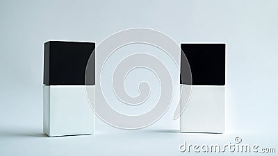 Two white square bottles with black caps on a white background. Stock Photo