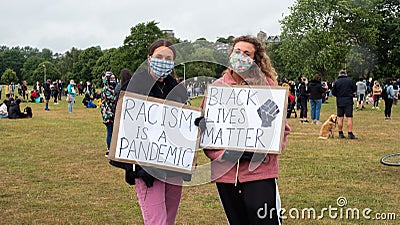 EXETER, DEVON, UK - June 06 2020: Two white women hold signs at a Black Lives Matter demonstration Editorial Stock Photo