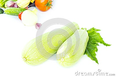 Two whole fresh green ripe zucchini or courgettes, object isolated on white background with vegetables Stock Photo