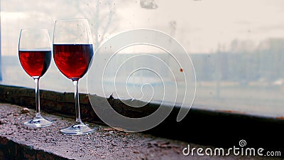 Two Wine glases on a background of old windows in abandoned house Stock Photo