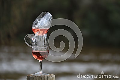 Two Wine Glasses Balanced With Rose, Outdoor Abstract Scene Stock Photo