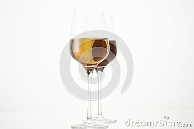 Two wineglasses half filled with red and white wine. Stock Photo