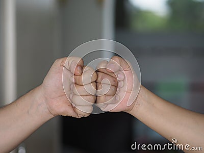 Two woman Alternative handshakes Fist collision Bump greeting in the situation of an epidemic covid 19, coronavirus Stock Photo