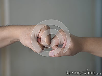 Two woman Alternative handshakes Fist collision Bump greeting in the situation of an epidemic covid 19, coronavirus Stock Photo