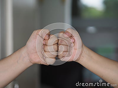 Two woman Alternative handshakes Fist collision Bump greeting in the situation of an epidemic covid 19, coronavirus Stock Photo