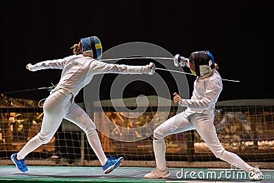 Two woman fencing athletes fight Stock Photo