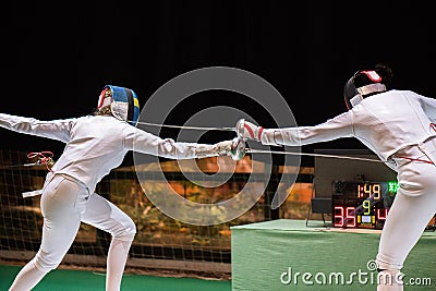 Two woman fencing athletes fight Stock Photo