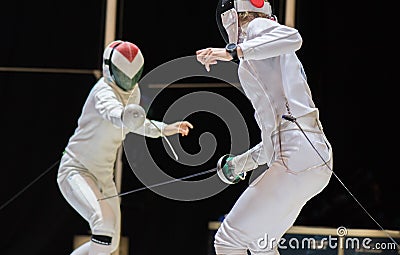 Two woman fencing athletes fight Stock Photo