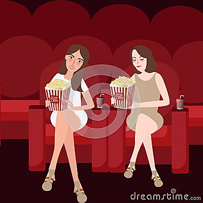 Two woman friends enjoy watching movies at cinema while eating popcorn friendship Stock Photo