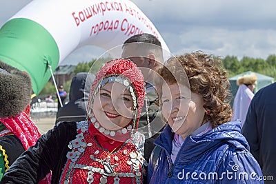 Two women are adults, one of them is in Bashkir national costume, other is not, at Muslim festival Editorial Stock Photo