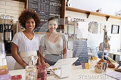 Two women behind the counter at a coffee shop, wide angle Stock Photo