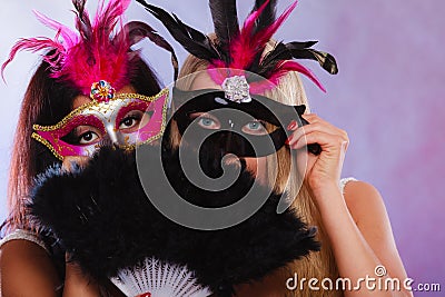 Two women with carnival venetian masks Stock Photo