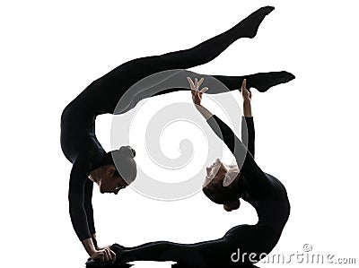 Two women contorsionist exercising gymnastic yoga silhouette Stock Photo