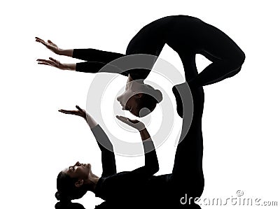 Two women contortionist exercising gymnastic yoga silhouette Stock Photo