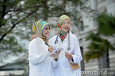 Two Women Doctor With Scarf, Outdoor Stock Photo