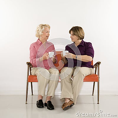 Two women drinkng coffee. Stock Photo