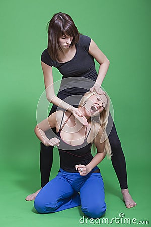 Two women fighting Stock Photo