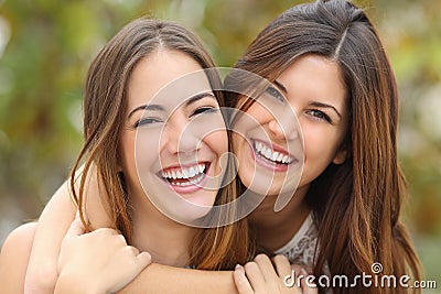 Two women friends laughing with a perfect white teeth Stock Photo