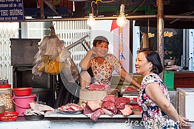 Two women are having a conversation at the wet market Editorial Stock Photo